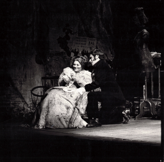 Singers Glenys Fowles and Anson Austin embrace on stage as Mimi and Rodolfo in the opera La Boheme.