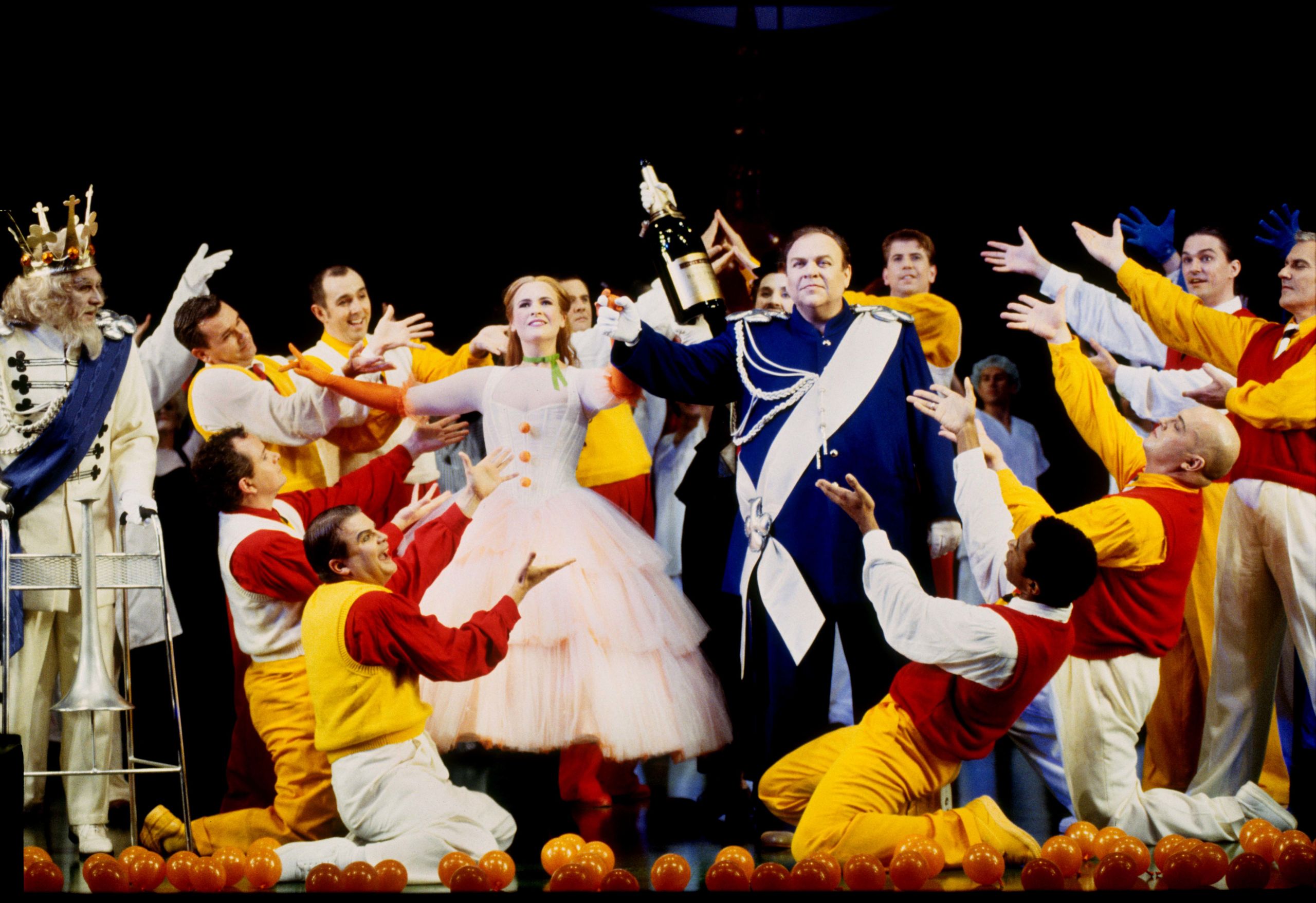 Singers Ali McGregor and John Mac Master stand in a celebratory pose in a performance of The Love for Three Oranges.