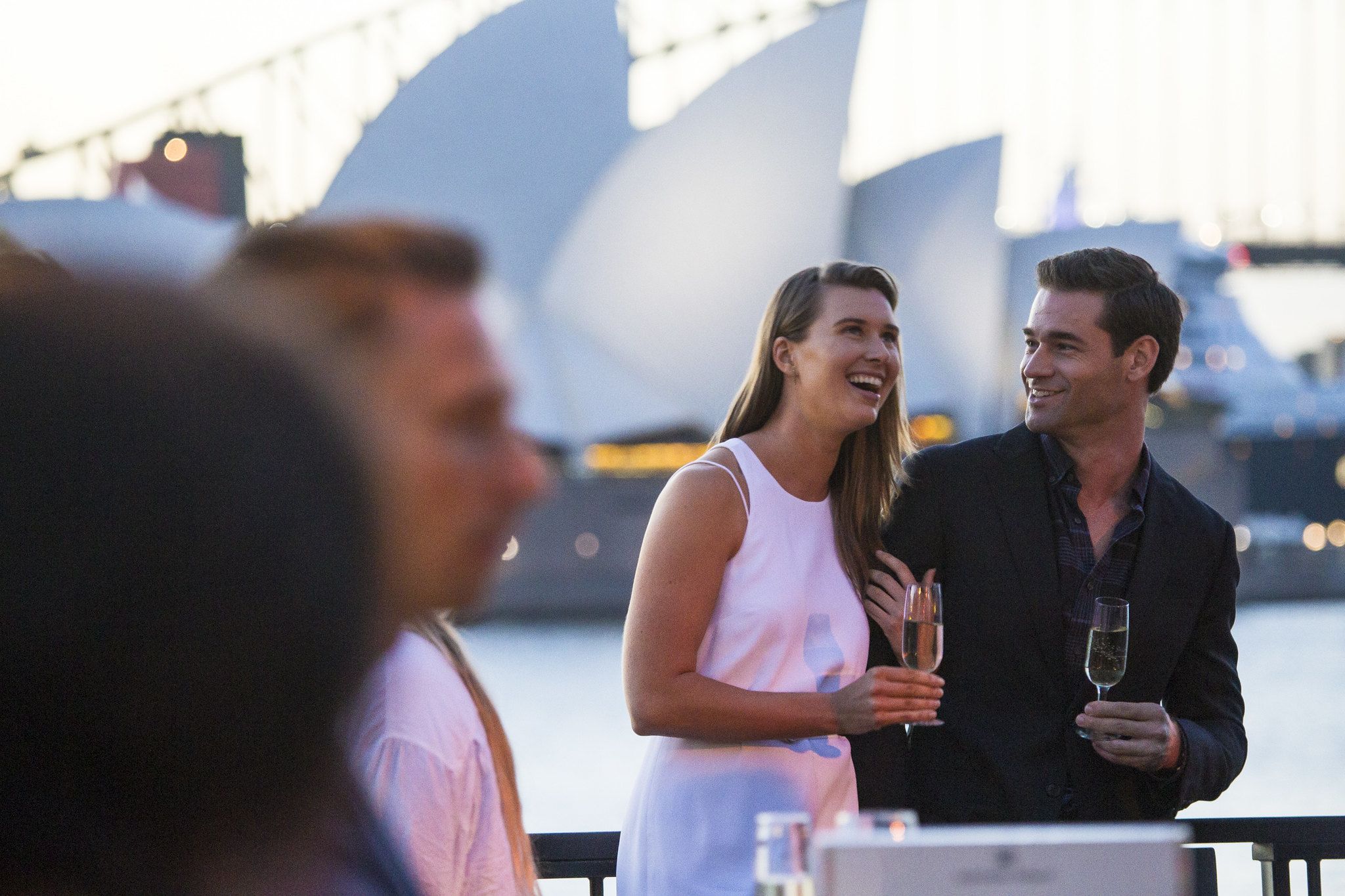 Audience members toasting champagne at Handa Opera on Sydney Harbour