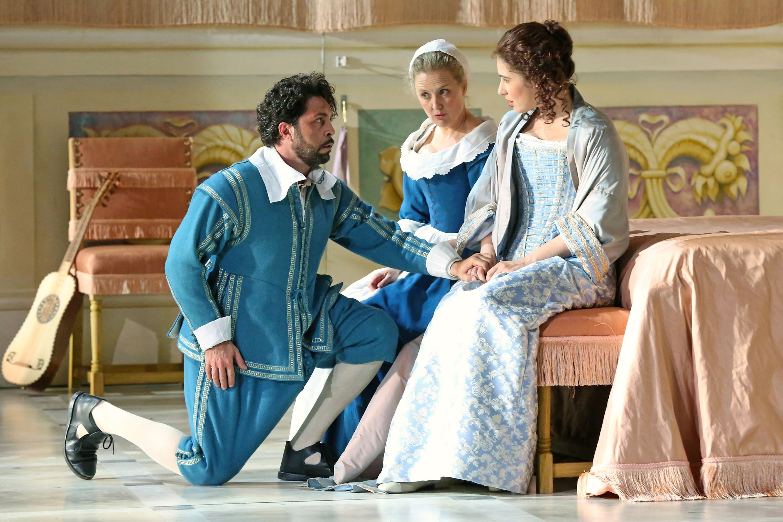 A man kneels before two women in a performance of The Marriage of Figaro.