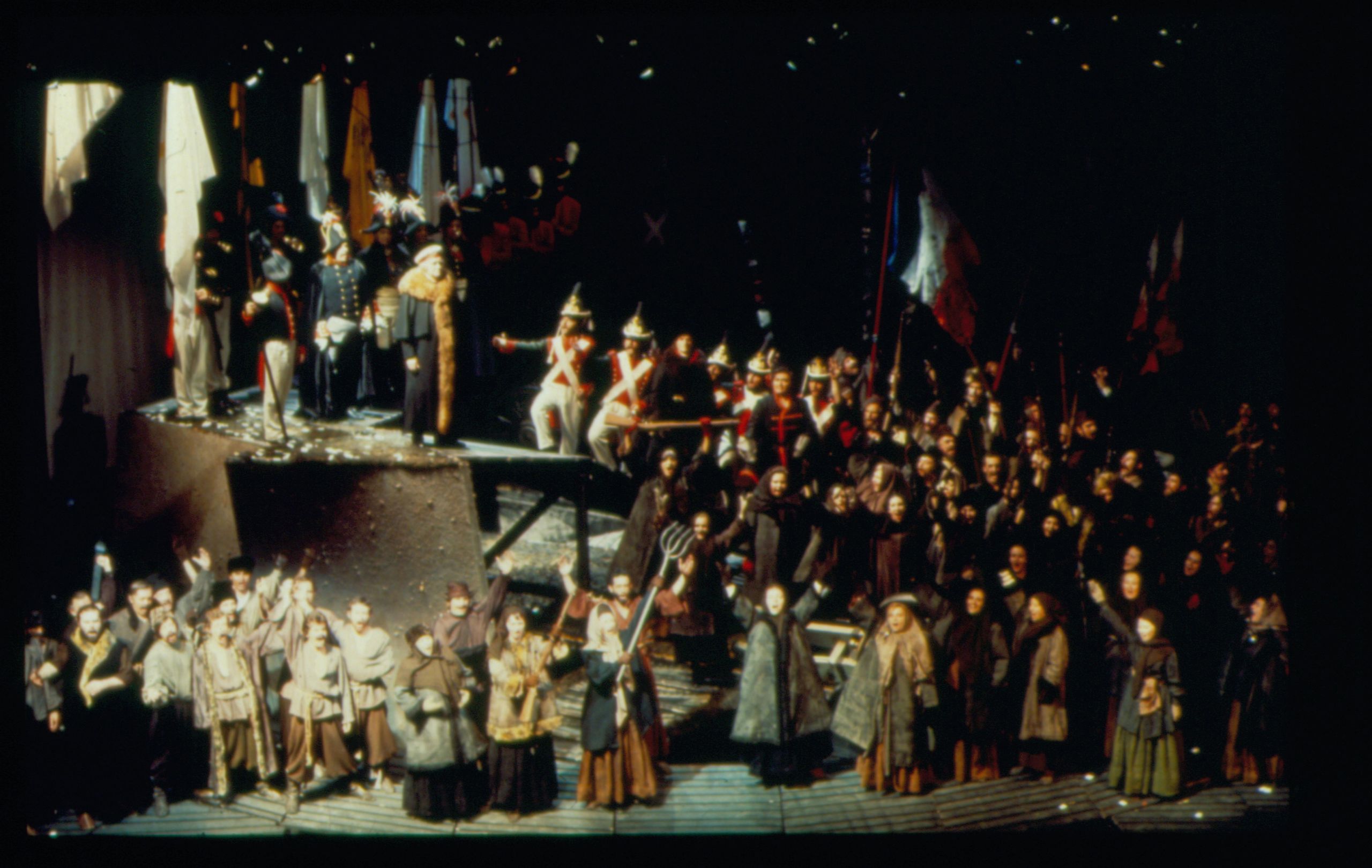 A group of singers in military costume stand on stage in a performance of War and Peace at the Sydney Opera House.